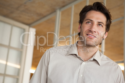Casual businessman thinking and smiling