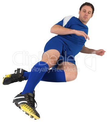 Football player in blue kicking