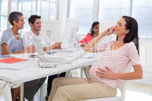 Businesswoman on the phone and strokes preganat belly