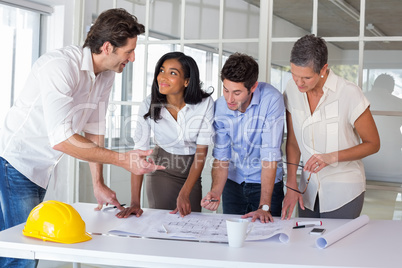 Team of architects going over blueprints