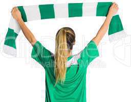 Cheering football fan waving scarf