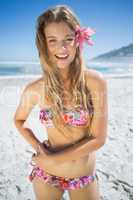 Beautiful smiling blonde with flower hair accessory on the beach