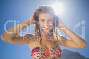 Beautiful smiling blonde in floral bikini on the beach