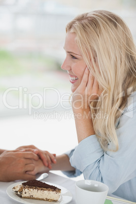 Cute couple having coffee together in cafe