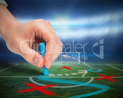 Hand drawing tactics on football pitch