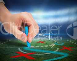 Hand drawing tactics on football pitch