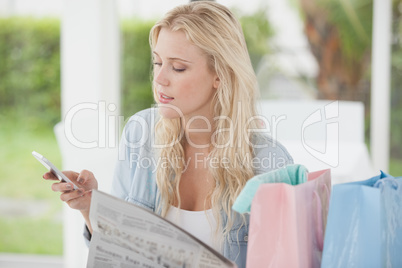 Cute blonde relaxing after shopping trip in cafe