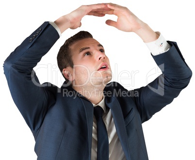 Businessman standing with hands over head