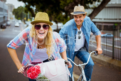 Hip young couple going for a bike ride