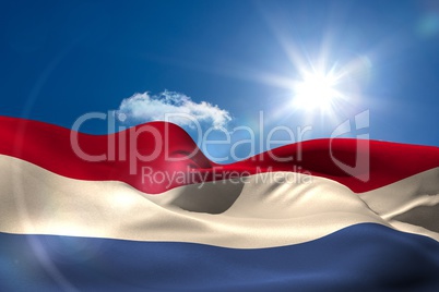 Dutch national flag under sunny sky