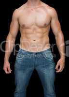 Muscular man posing shirtless in blue jeans