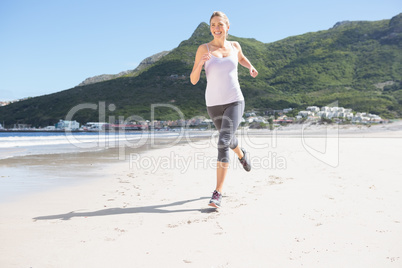 Pretty blonde jogging on the beach