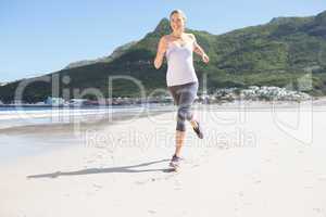 Pretty blonde jogging on the beach