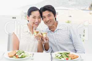 Happy asian couple having meal together