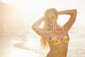 Gorgeous blonde in floral bikini posing at the beach