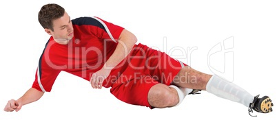 Football player in red kicking