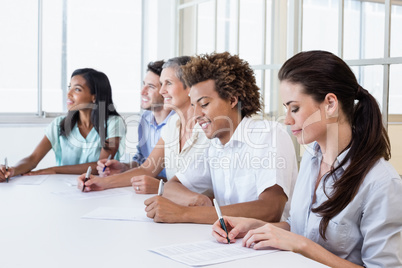 Casual business team taking notes in meeting