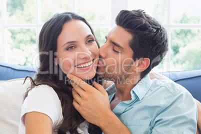 Attractive couple cuddling on the couch