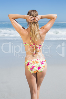 Blonde fit woman in floral bikini at beach