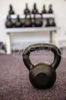Black kettlebell on the weights room floor