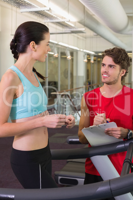 Trainer talking to his client on the treadmill