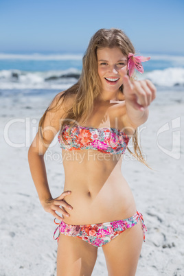 Beautiful happy blonde with flower hair accessory on the beach