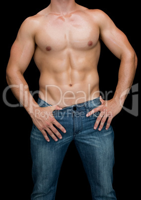 Muscular man posing shirtless in blue jeans