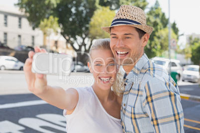 Young hip couple taking a selfie