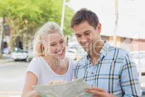 Young tourist couple consulting the map