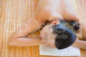 Content brunette relaxing on massage table