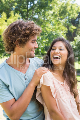 Cute couple relaxing on park bench