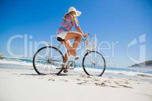 Pretty blonde on a bike ride at the beach