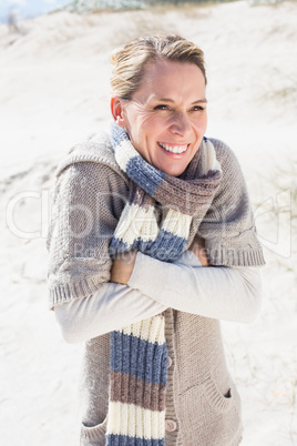 Attractive shivering blonde standing on the beach