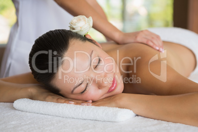 Brunette enjoying a peaceful massage with eyes closed