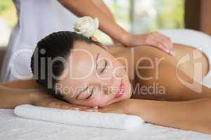 Brunette enjoying a peaceful massage with eyes closed