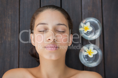 Peaceful brunette lying with eyes closed