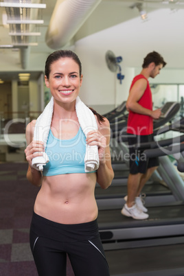 Smiling brunette with towel over shoulders