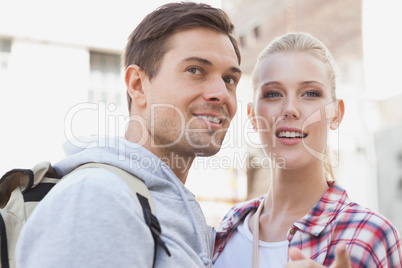 Young tourist couple smiling at something