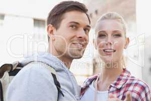 Young tourist couple smiling at something