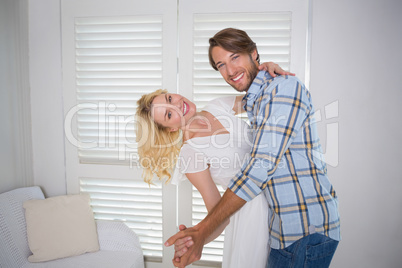 Cute young couple dancing together