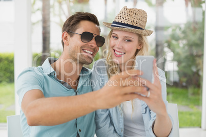 Hip young couple taking a selfie together