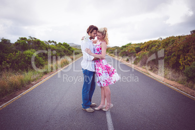 Cute couple standing on the road hugging