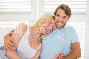 Young couple sitting on the couch laughing