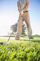 Golfer about to hit golf ball