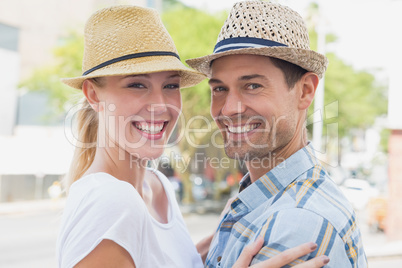 Young hip couple hugging and smiling at camera Young hip couple hugging and smiling at camera