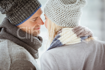 Couple in warm clothing facing each other