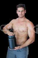 Muscular man posing with nutritional supplement