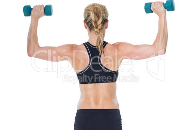 Female bodybuilder holding two dumbbells with arms up