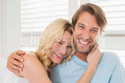 Young couple sitting on the couch laughing