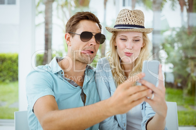 Hip young couple taking a selfie together